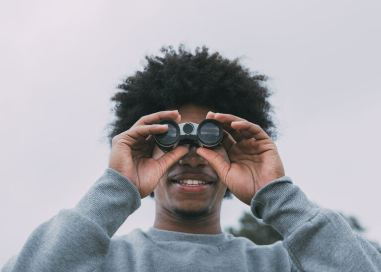 man-looking-through-binoculars