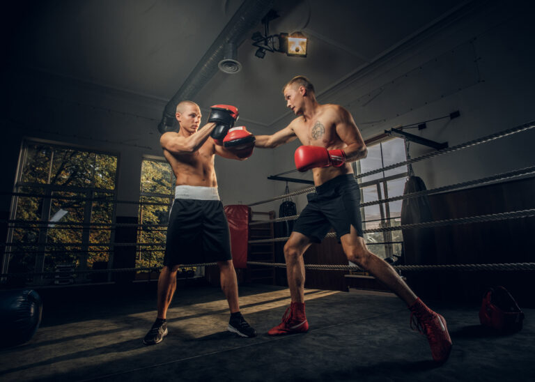 Two sportive men have a boxing competition on the ring
